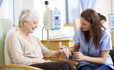 senior woman undergoing chemotherapy with nurse
